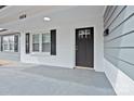 Welcoming front porch with freshly painted floors and a traditional style front door at 1404 Nottingham Rd, Kannapolis, NC 28081