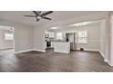 Open-concept living area featuring gray walls and new dark wood flooring at 1404 Nottingham Rd, Kannapolis, NC 28081