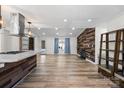 Open-concept living room with a wood accent wall and fireplace and a kitchen island at 1536 Plyler Lake Rd, Gastonia, NC 28054