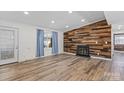 Spacious living room featuring a wood accent wall with fireplace and stylish hardwood flooring at 1536 Plyler Lake Rd, Gastonia, NC 28054