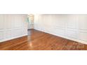 Bright and airy living room with gleaming hardwood floors and decorative wall trim at 1831 Jameston Dr, Charlotte, NC 28209