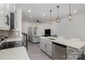 Open concept kitchen seamlessly connects to living area, featuring stainless steel appliances, island and modern lighting at 2004 Crooked Oak Ln, York, SC 29745