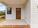 Inviting front porch featuring a beautiful wood door with glass inserts and brick accents at 2615 Brentwood Pl, Charlotte, NC 28208