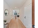 Bright hallway with light wood floors leading into a spacious living area at 2615 Brentwood Pl, Charlotte, NC 28208