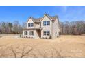 Side view of the home showing the brick facade and low maintenance vinyl siding at 2622 Old Camden Rd, Monroe, NC 28110