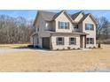 Home exterior featuring attached garage and brick front on a neatly manicured lawn at 2622 Old Camden Rd, Monroe, NC 28110