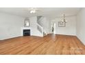 Bright living room features hardwood floors, a fireplace, and a staircase to the upper level at 2944 Caldwell Ridge Pkwy, Charlotte, NC 28213