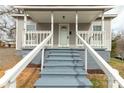 Close-up view of the home's front porch showcasing the painted stairs and white railings at 305 Flat Rock St, Clover, SC 29710
