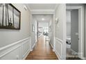 Inviting hallway with wood floors and white wainscoting, leading to the living spaces at 333 Dudley Dr, Fort Mill, SC 29715