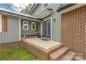 Charming home entrance featuring double doors, brick accents, and a welcoming front porch at 360 Patience Dr, Concord, NC 28025