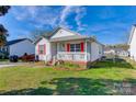 Cozy single-story home with white siding, red shutters, and a small front porch at 376 Brookgreen Nw Pl, Concord, NC 28027