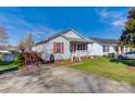 Cozy home with a welcoming front porch and red shutters, showcasing the property's curb appeal in a friendly neighborhood at 376 Brookgreen Nw Pl, Concord, NC 28027