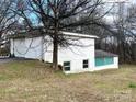 Spacious detached two car garage with additional storage space and a tree nearby at 4137 Poplar Tent Rd, Concord, NC 28027