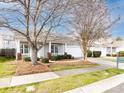 Inviting one-story home showcases an attached two-car garage, landscaped front yard, and a covered front porch at 415 Ridgely Green Dr, Pineville, NC 28134