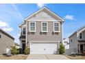 Charming two-story home featuring a gray exterior, a two-car garage, and well-maintained landscaping at 439 Newfound Hollow Dr, Charlotte, NC 28214