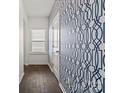 Hallway with window and white door featuring a stylish patterned blue wallpaper for a modern touch at 439 Newfound Hollow Dr, Charlotte, NC 28214