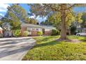 Large front yard with driveway leading to this cozy one story home at 4635 General Pershing Dr, Charlotte, NC 28209