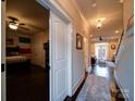 Inviting hallway with hardwood floors leads to bedroom and living room with natural light at 508 Summerfield Pl, Belmont, NC 28012