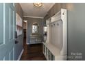 Stylish foyer with a coat rack, a modern table with a mirror, and views into other living spaces at 5615 Starkwood Dr, Charlotte, NC 28212