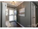 Elegant entryway featuring a decorative light fixture, a modern art piece, and a light blue front door at 5615 Starkwood Dr, Charlotte, NC 28212