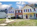 Attractive townhome exteriors with covered porches, tidy landscaping, and walkways at 6210 Windsor Gate Ln, Charlotte, NC 28215