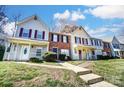 Inviting townhomes with well-manicured lawns, walkways, and charming covered front porches at 6210 Windsor Gate Ln, Charlotte, NC 28215