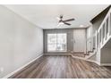 Bright living room featuring hardwood floors, large windows, and a modern ceiling fan at 6210 Windsor Gate Ln, Charlotte, NC 28215