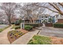 Beautiful condo complex entrance featuring mature landscaping and manicured lawn at 623 Olmsted Park Pl # D, Charlotte, NC 28203