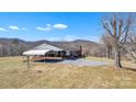Home exterior showcasing a spacious yard and covered parking, ideal for outdoor activities and convenience at 6285 Nc 16 N Hwy, Taylorsville, NC 28681