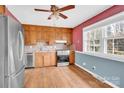 Traditional kitchen featuring wood cabinetry, a stainless steel refrigerator, and plenty of natural light at 6308 Lake Forest E Rd, Charlotte, NC 28227