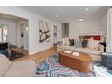 Bright living room with modern decor, hardwood floors, and open access to other areas of the home at 6319 Hazelton Dr, Charlotte, NC 28210