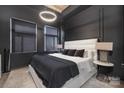 Contemporary bedroom with dark walls, ambient lighting, and a large bed with plush pillows and linens at 715 N Church St, Charlotte, NC 28202