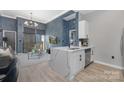 Open-concept kitchen with stainless appliances, quartz countertops, and views into the living area and balcony at 715 N Church St, Charlotte, NC 28202