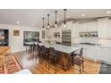 Open kitchen showcasing a large central island with seating, stainless steel appliances, and hardwood floors at 810 Bridgewood Dr, Rock Hill, SC 29732