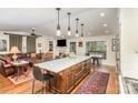 Open-concept kitchen with island, flowing into the living area with fireplace and built-in shelving at 810 Bridgewood Dr, Rock Hill, SC 29732