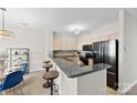 Modern kitchen boasts granite countertops, stainless steel appliances, and a breakfast bar with stool seating at 921 Northeast Dr # 26, Davidson, NC 28036