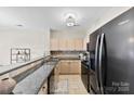 Well-equipped kitchen features granite counters, a tile backsplash, stainless steel appliances, and ample cabinet space at 921 Northeast Dr # 26, Davidson, NC 28036