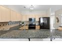 Updated kitchen has granite countertops, stainless steel appliances, a tile backsplash, and a modern faucet at 921 Northeast Dr # 26, Davidson, NC 28036