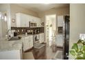 Well-lit kitchen features granite countertops, stainless steel appliances and tile backsplash at 1004 Canopy Dr, Indian Trail, NC 28079