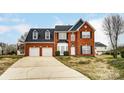 Attractive brick two-story home with attached two-car garage, showcasing its inviting curb appeal at 12332 Ridge Cove Cir, Charlotte, NC 28273