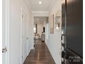 Bright entryway featuring hardwood floors, white walls, and decorative accents, leading into a living area at 167 Shepherds Landing Dr, Mooresville, NC 28115