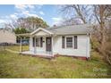 Adorable one-story home with a welcoming covered porch and shuttered windows at 1893 Hilltop Cir, Gastonia, NC 28054