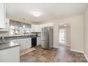 Spacious kitchen with stainless steel appliances, generous counter space, and updated flooring at 1911 Woodlawn St, Kannapolis, NC 28083