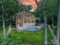 A beautiful backyard with a pool, patio, and lush greenery, perfect for outdoor living and entertaining at 20338 Christofle Dr, Cornelius, NC 28031