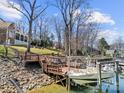 Private boat dock with boat lift and deck area, ideal for waterfront living and boating enthusiasts at 20338 Christofle Dr, Cornelius, NC 28031
