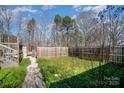 Fenced backyard featuring a stone pathway and lush green ground cover at 240 Old Limestone E Rd, York, SC 29745