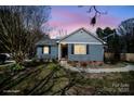 Charming single-story home featuring blue siding, black shutters, and a cozy front yard at 240 Old Limestone E Rd, York, SC 29745