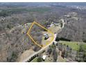 Overhead view of a home surrounded by trees, showcasing its spacious lot at 257 Hickory Hill Ln, Stanley, NC 28164