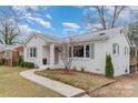 Beautiful white brick house with green shutters and a curved walkway leading to the front door at 3504 Meredith Ave, Charlotte, NC 28208