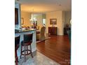 Open-concept living space with hardwood floors connecting dining and kitchen areas at 422 Drake Ln, Salisbury, NC 28146